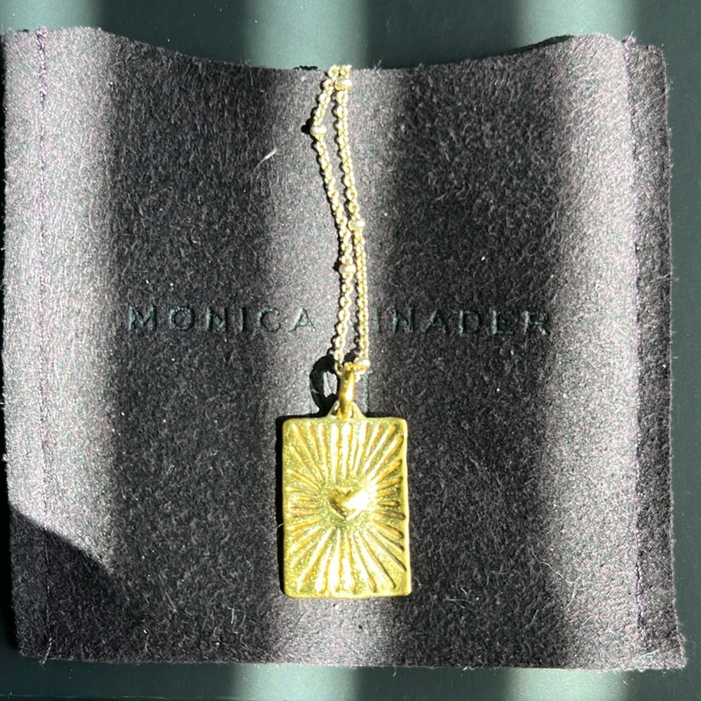 Gold Monica Vinader charm necklace.